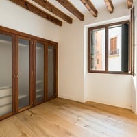 Spacious living room with fireplace, sea view through large windows. Modern design, neutral tones and natural light.