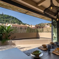 Spacious terrace with wooden flooring, panoramic views, designer furniture, and abundant natural light. Ideal for relaxation.