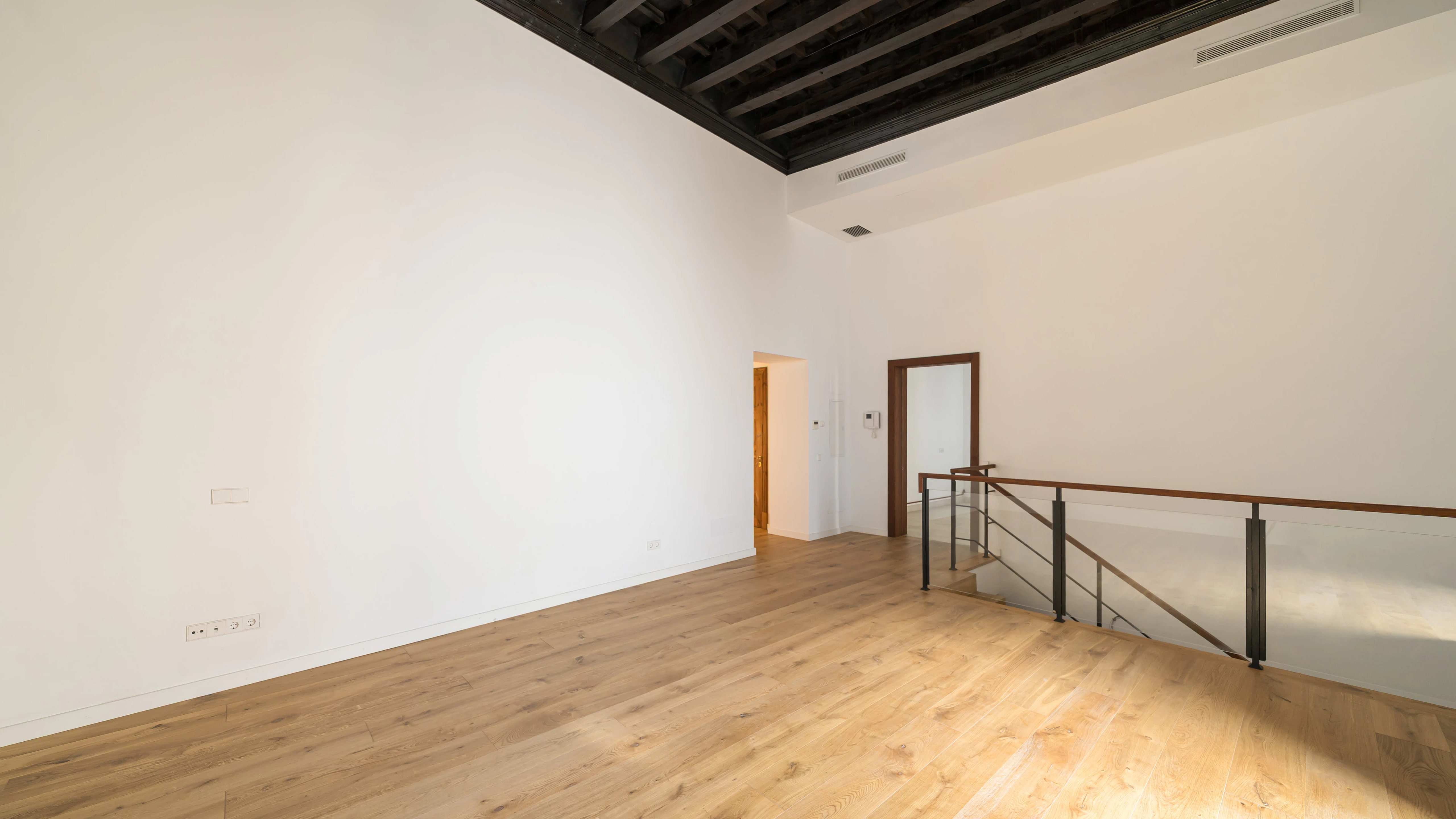 Exterior of a modern villa featuring an infinity pool and ocean views. Minimalist architecture with large windows and sleek design.