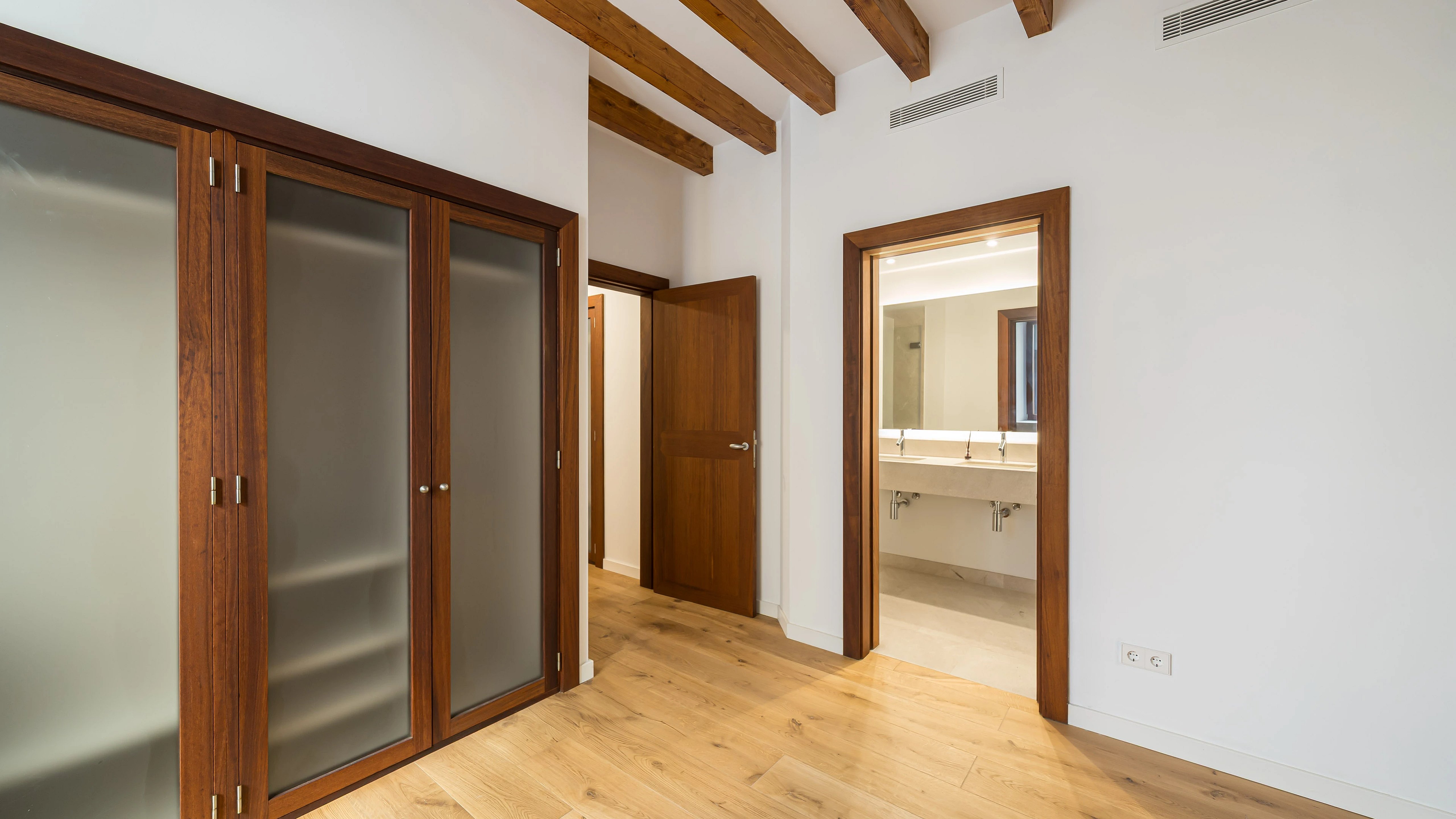 Bright interior with sea view. Large windows, modern furniture, wood floor and neutral color palette. Elegant design.