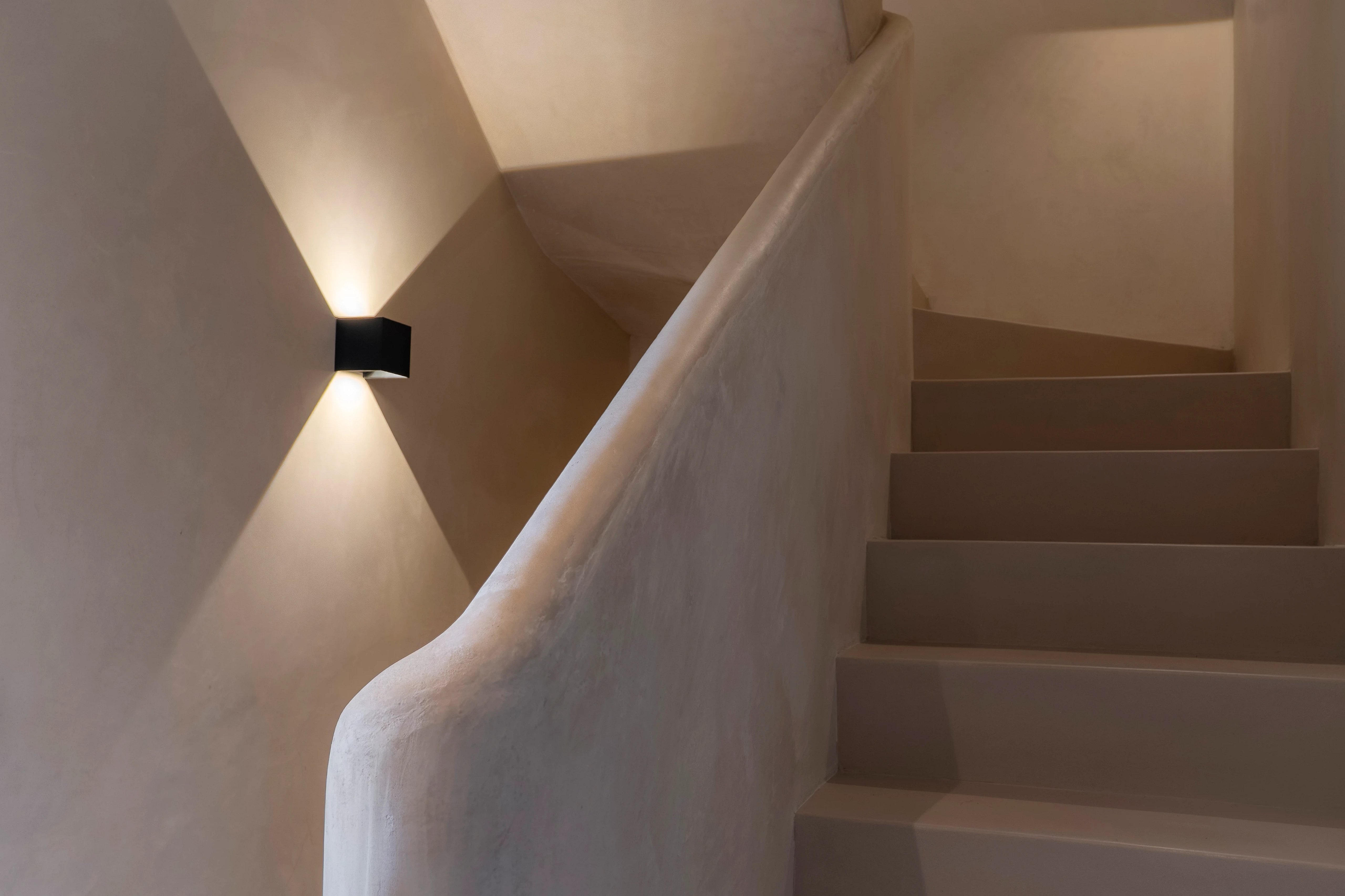 Modern balcony with wood flooring, glass railing, and panoramic view. Soft lighting and minimalist design.