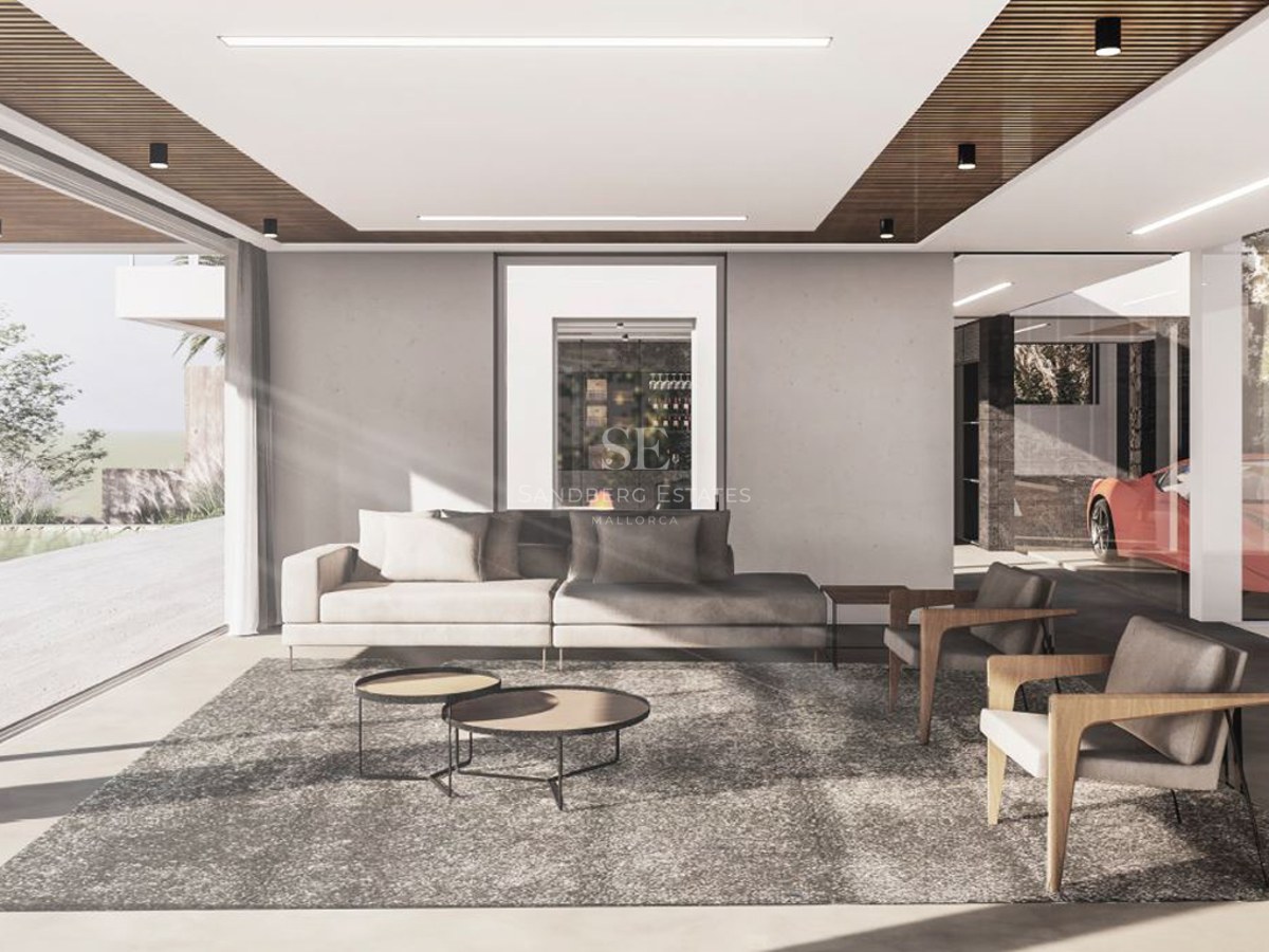 Minimalist living room with a grey sofa, wooden armchairs, and floor-to-ceiling windows showing a bright outdoor area.