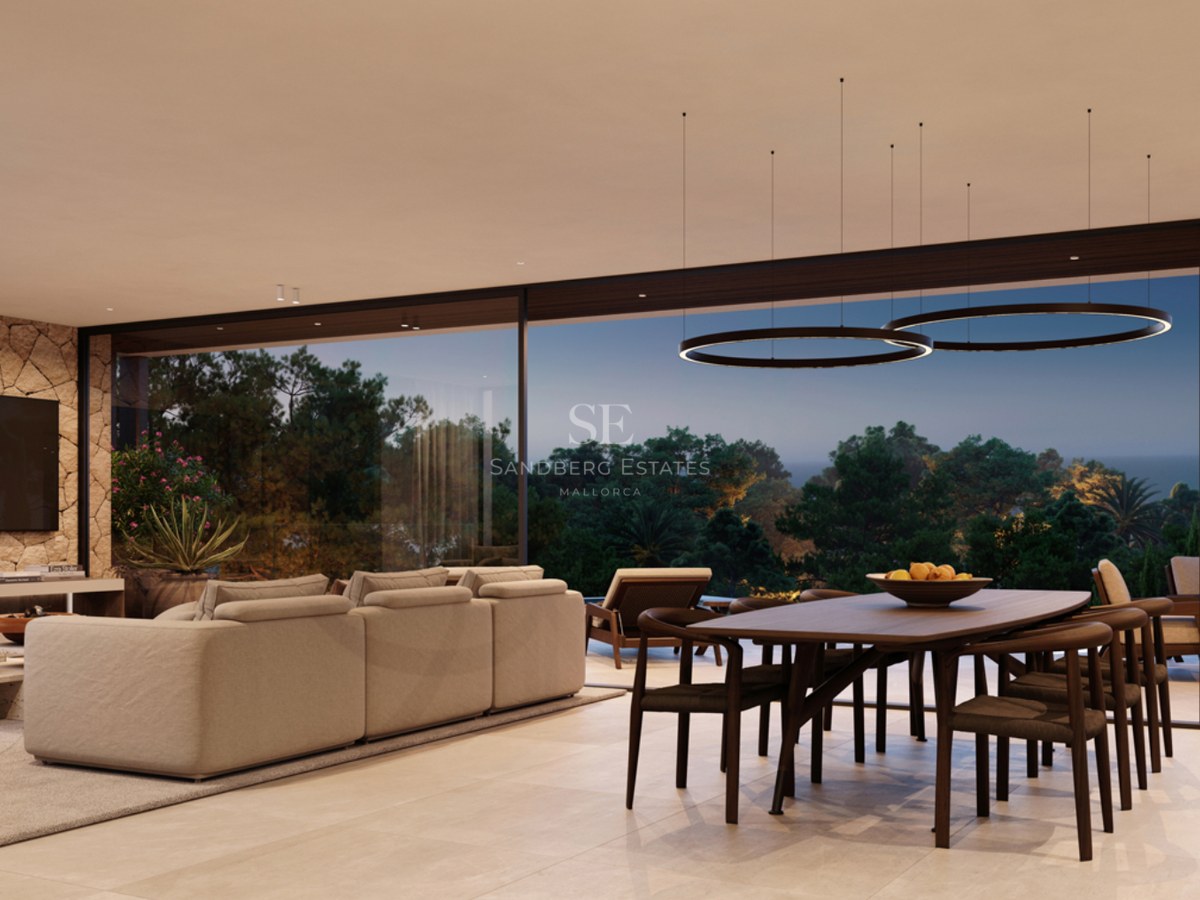 A spacious modern living room with a large sofa, wooden dining set, and floor-to-ceiling windows overlooking trees.