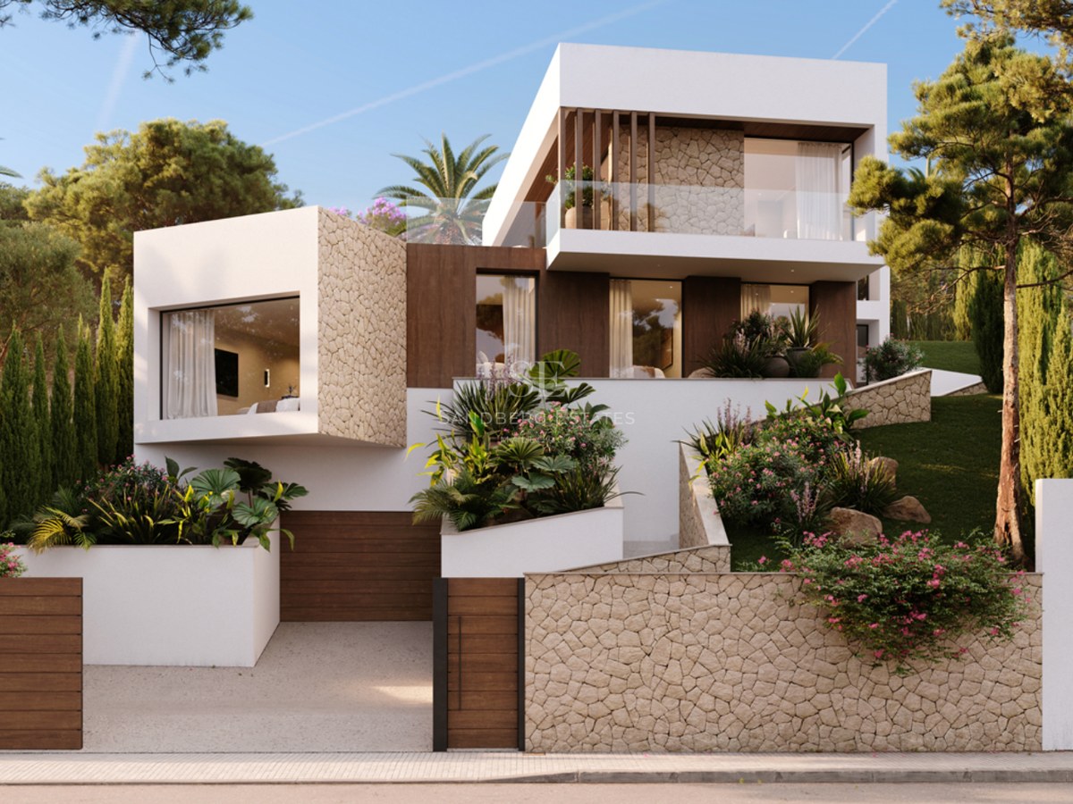A three-story modern white villa with textured stone walls, wooden accents, and lush tiered gardens under a clear sky.