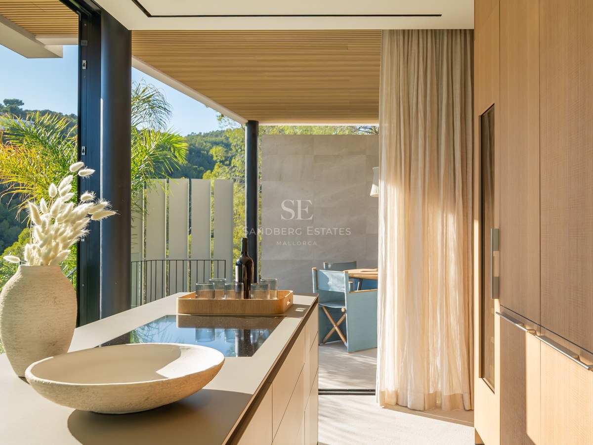 Expansive terrace featuring an infinity pool, ocean views, and modern furniture. Minimalist architecture with high-end finishes.
