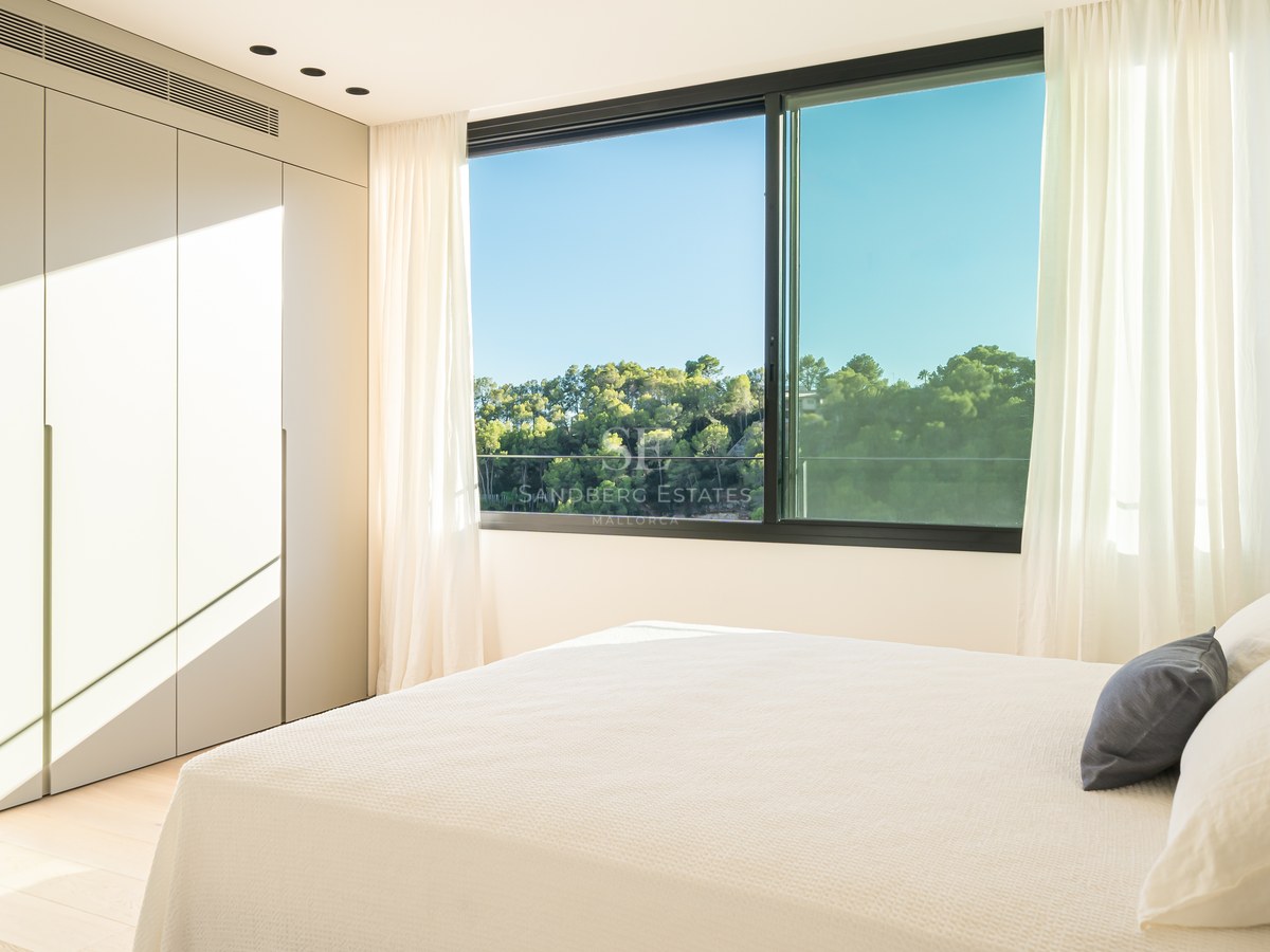 View of a luxurious villa with an infinity pool. Modern architecture, large windows, and manicured landscaping. Elegant and sophisticated design.