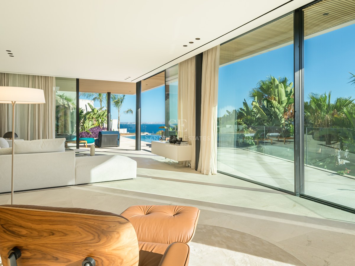 Terrace view with infinity pool and ocean view. Modern design, elegant outdoor furniture, and manicured landscaping.