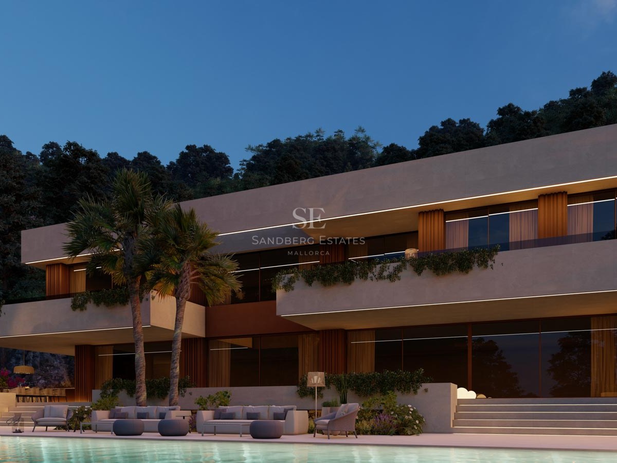 Modern villa i skymning med belyst infinitypool, loungemöbler och palmer mot en mörk kvällshimmel.