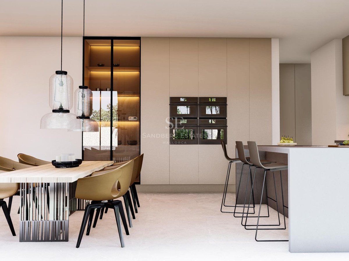 Contemporary kitchen featuring marble floors, a large wooden dining table, and integrated high-end appliances.