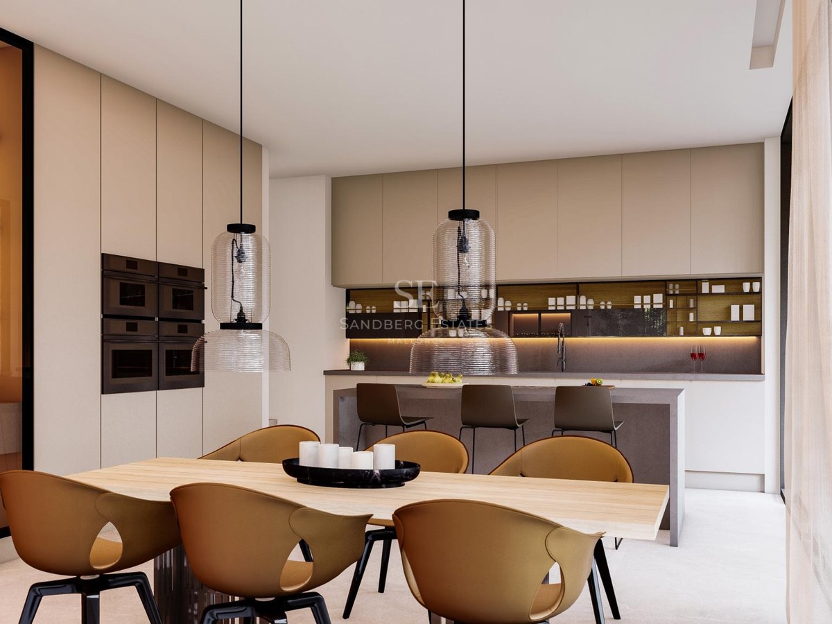 Modern kitchen with beige cabinetry, island with bar stools, and wooden dining table with mustard chairs.