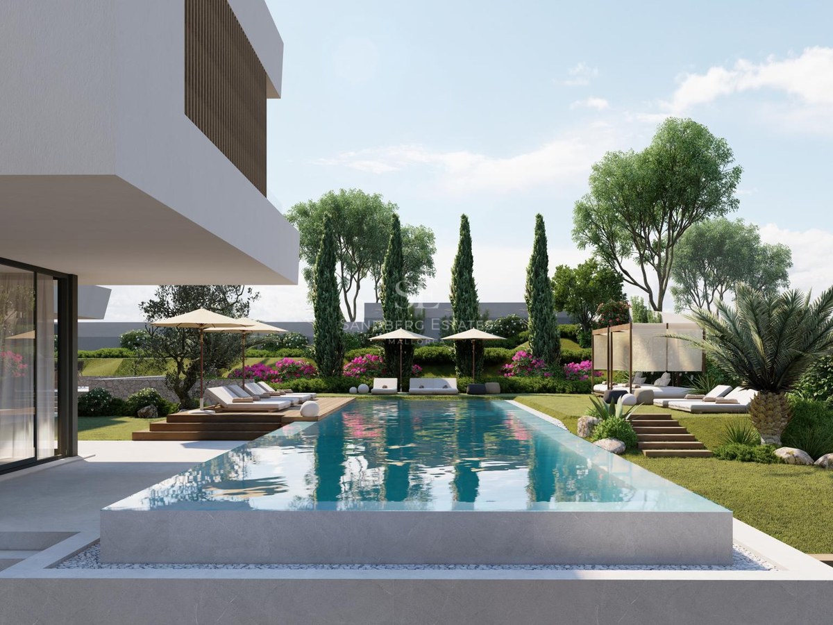 Luxury infinity pool with stone edges overlooking a landscaped garden with sunbeds and a modern white villa.