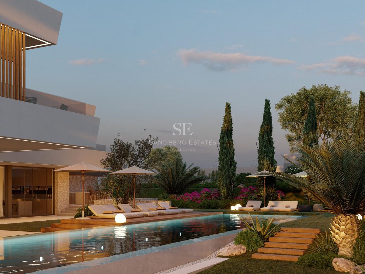 Illuminated lap pool flanked by wooden decking and a modern white villa with Mediterranean landscaping at twilight.