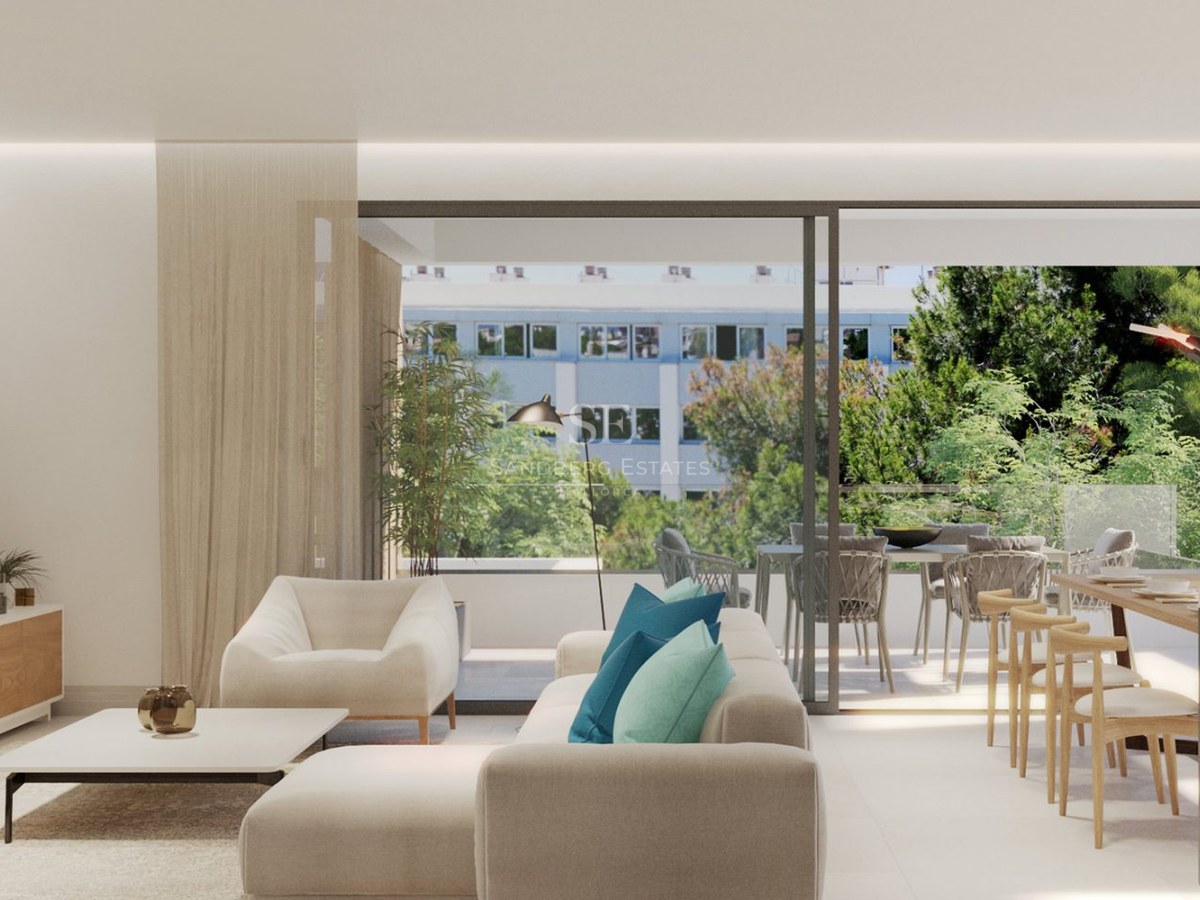 Bright modern living room with a white sectional sofa, blue pillows, dining area, and large sliding doors to a terrace.