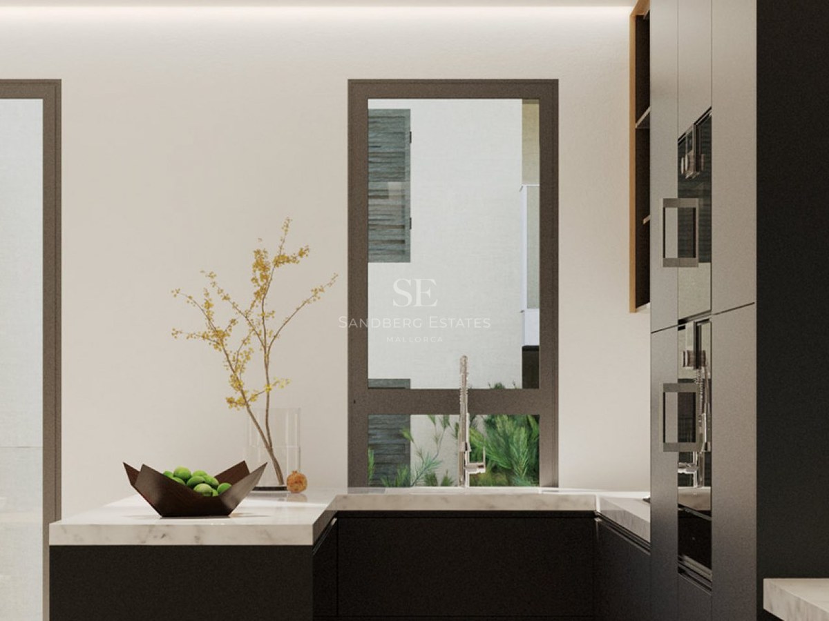 Modern kitchen featuring marble countertops, dark cabinetry, and a window with a view of outdoor greenery.