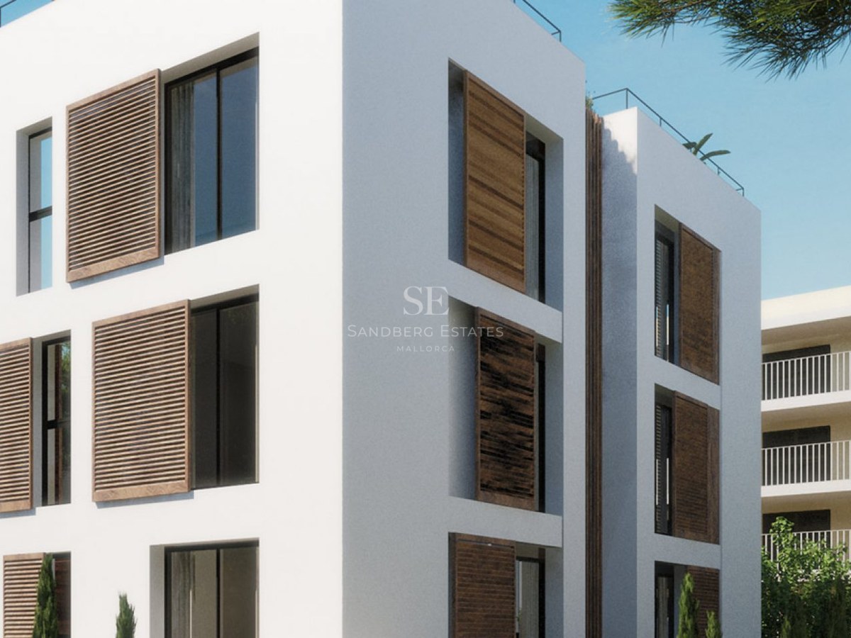 Modern white multi-story building featuring large windows with sliding wooden louvered shutters under a clear blue sky.