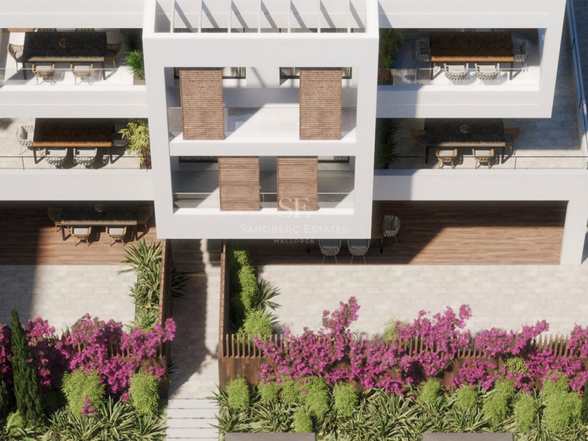 High-angle view of a white modern apartment building with wooden shutters, terraces, and a garden with purple flowers.