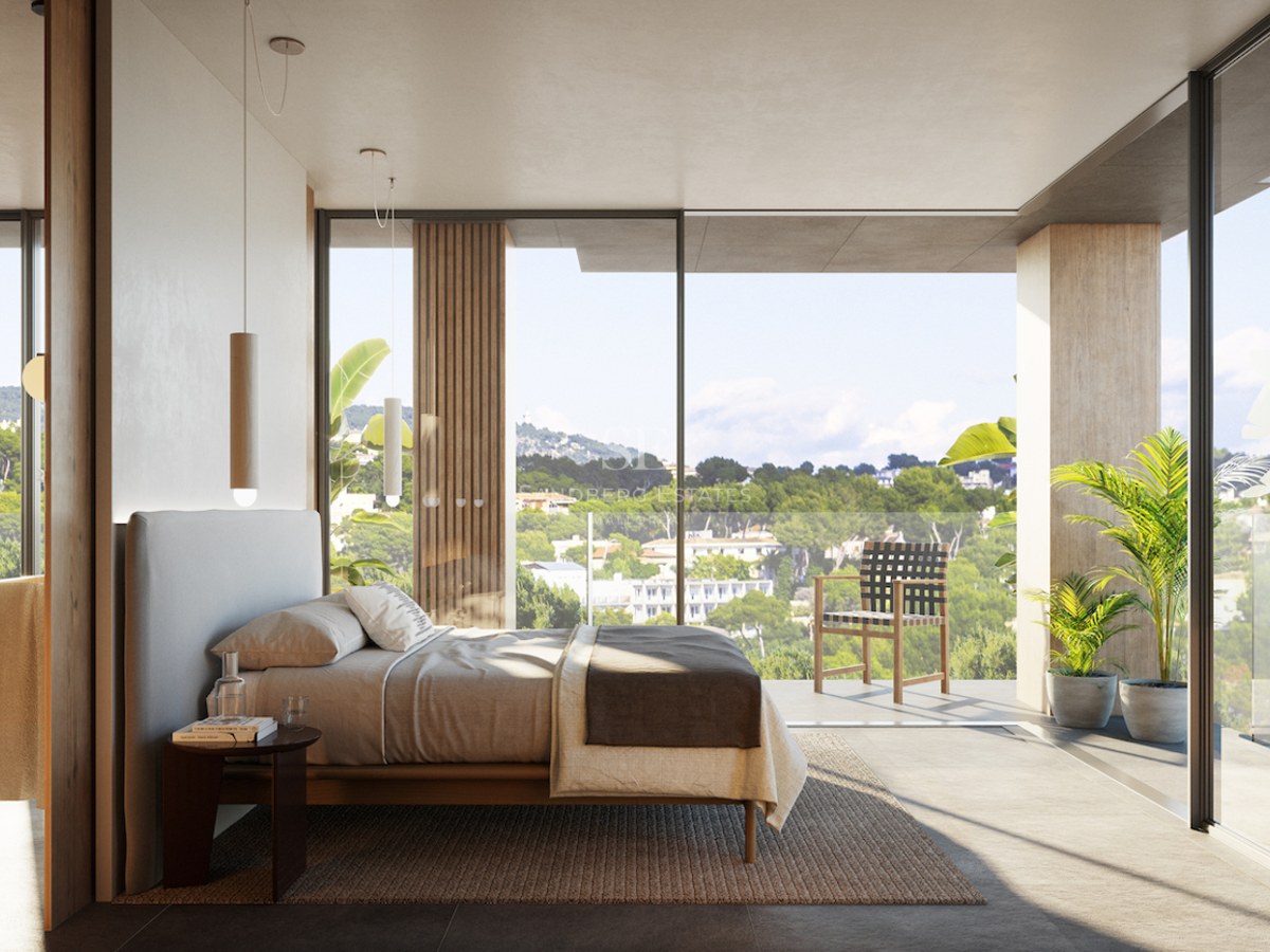 Bright master bedroom with floor-to-ceiling windows overlooking a lush landscape and a private terrace.