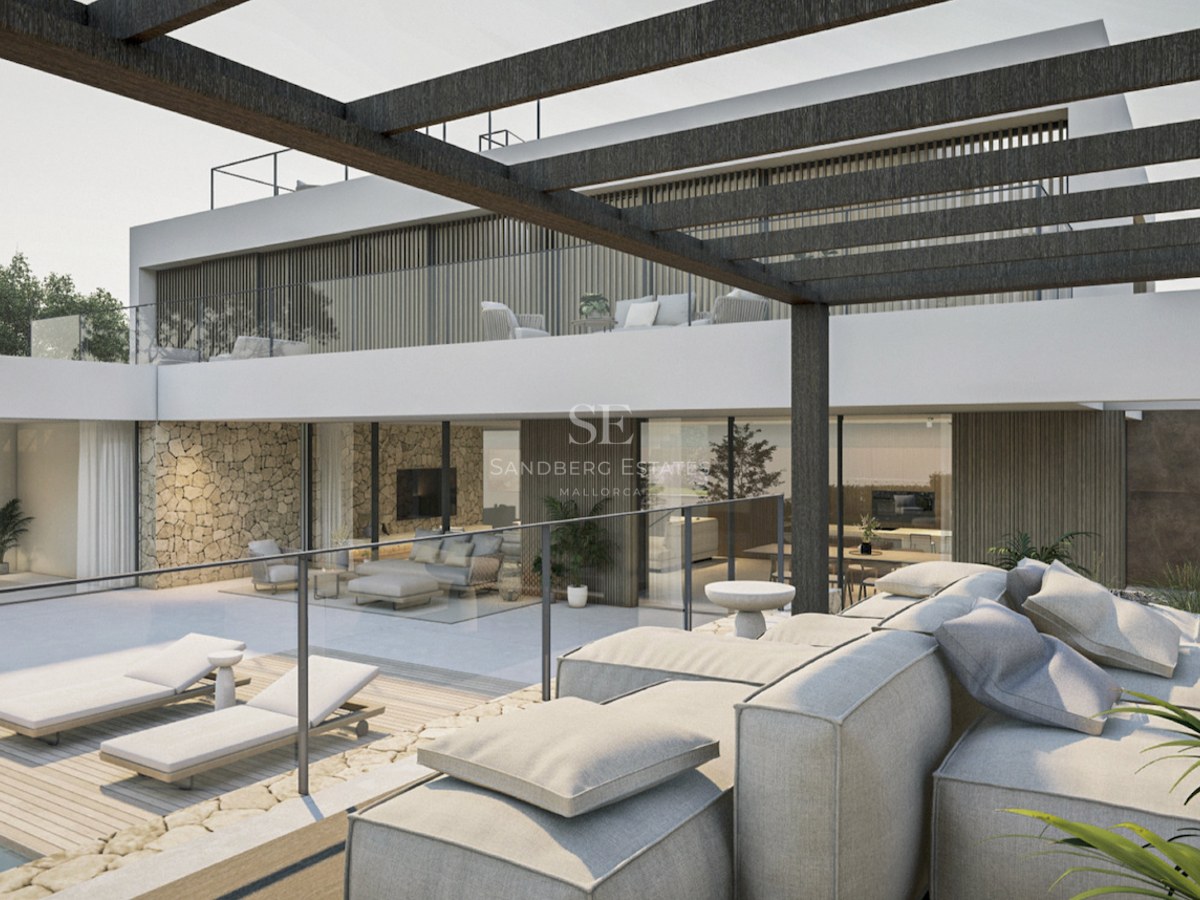 Terrasse de villa moderne avec canapés gris, chaises longues, pergola sombre et murs en pierre naturelle.