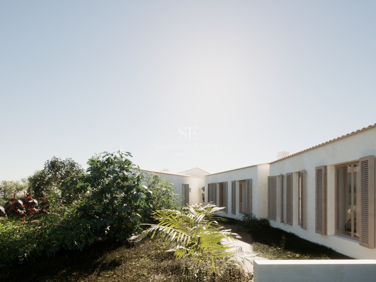 White Mediterranean villa exterior featuring wooden shutters and lush garden landscaping under a clear sky.