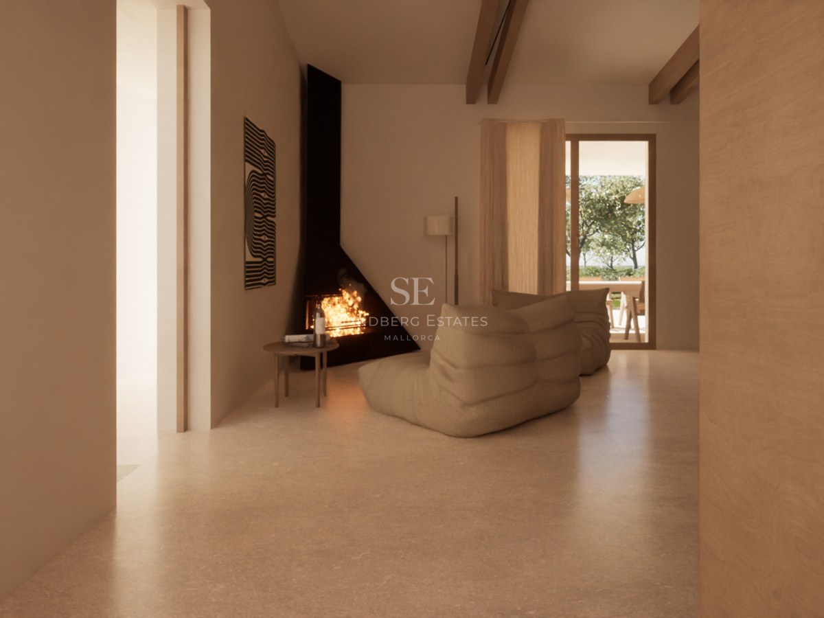 A minimalist living room featuring a black corner fireplace, beige lounge seating, and wooden ceiling beams.