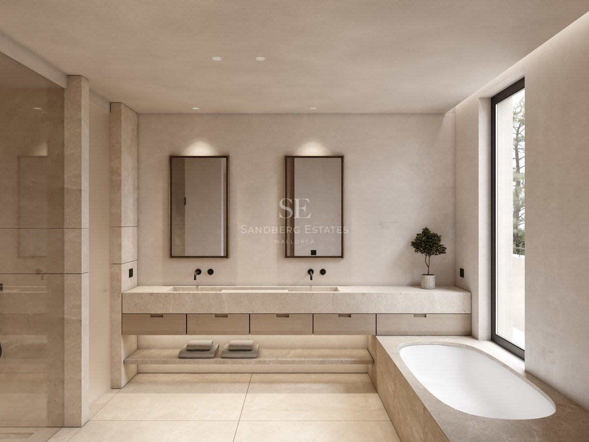 Salle de bain de luxe avec double vasque en pierre, baignoire intégrée et grande fenêtre lumineuse.