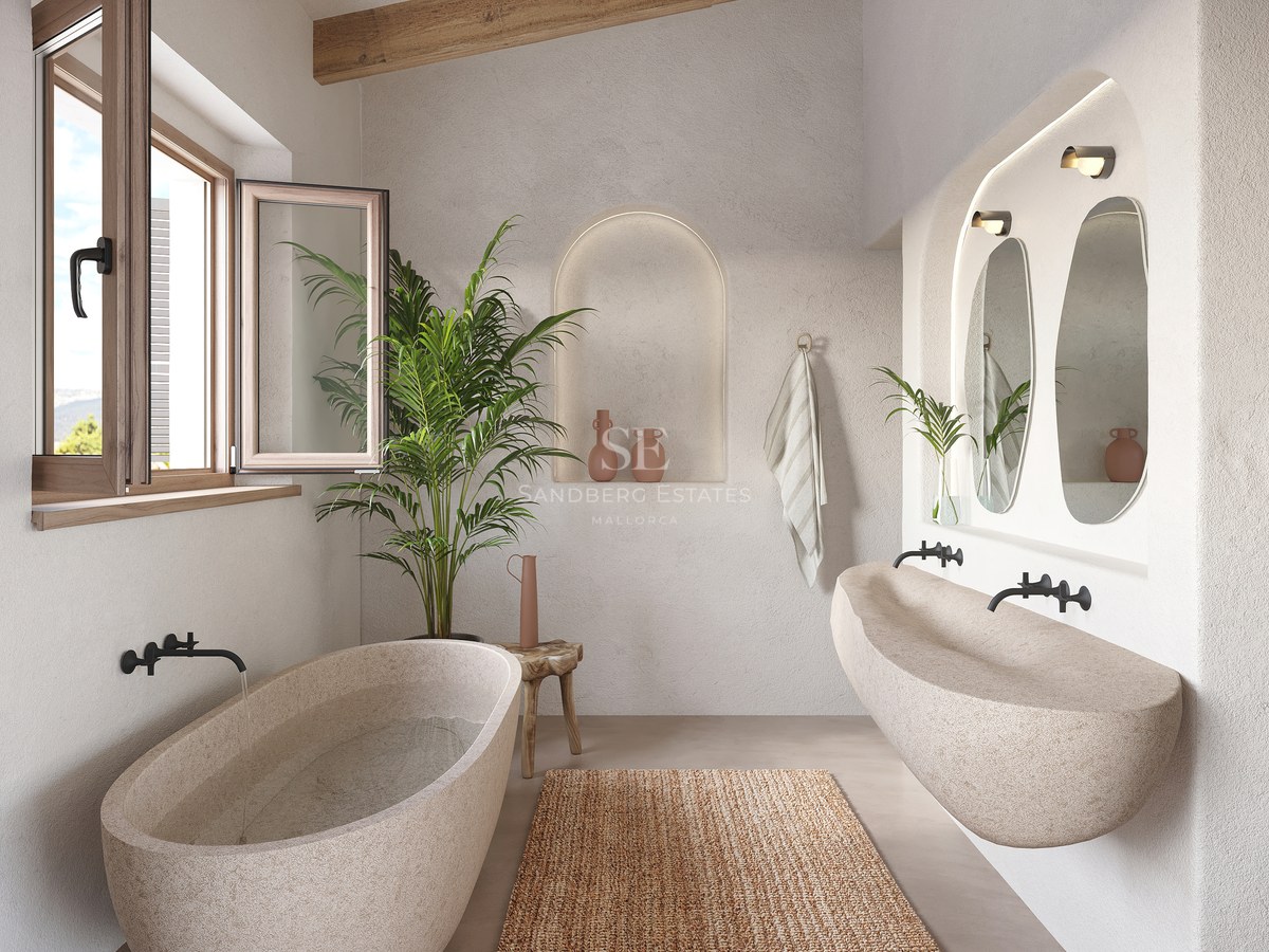 Baignoire et lavabo en pierre sculptée dans une salle de bain avec poutres en bois et murs en plâtre.