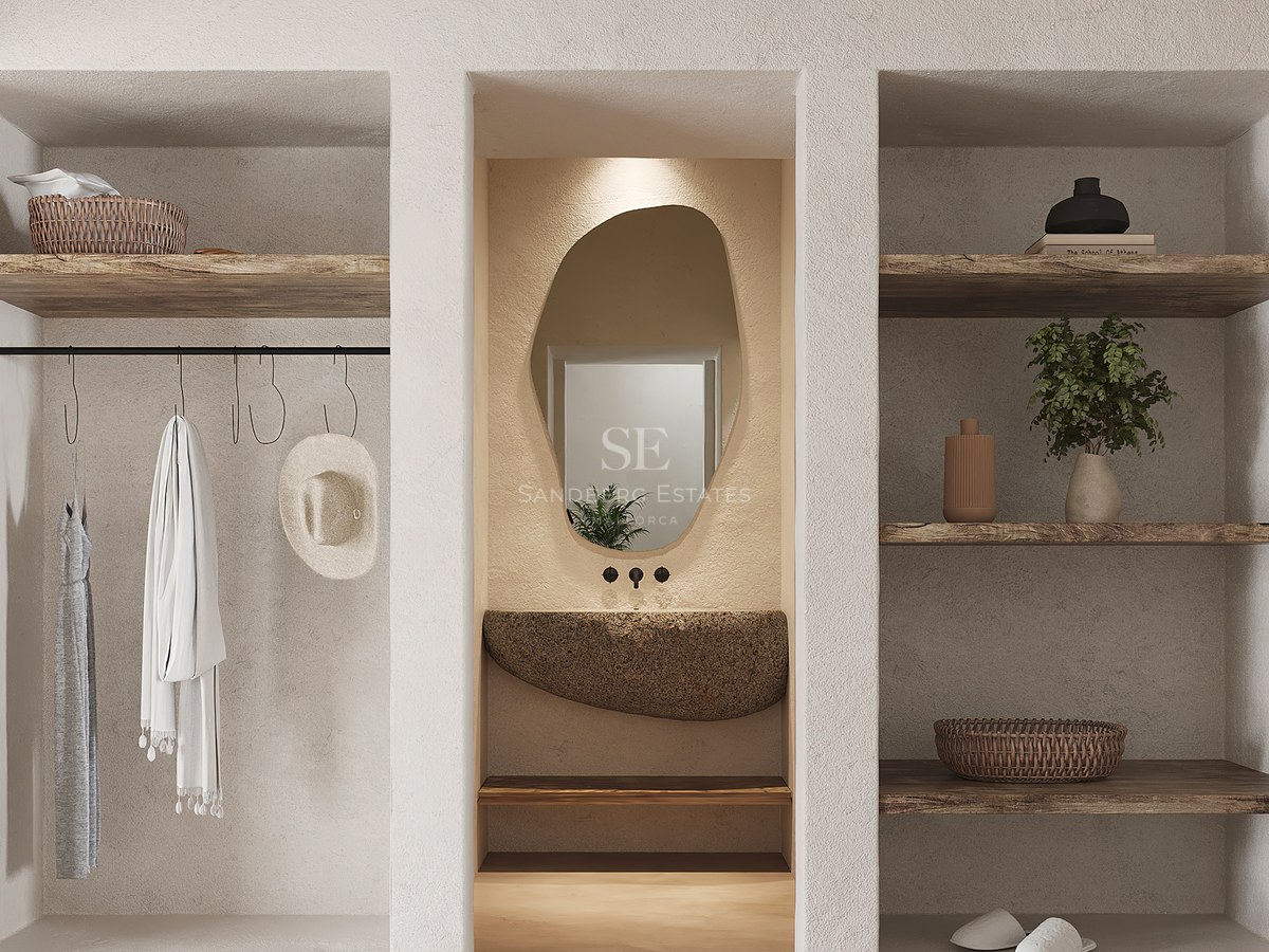 Dressing avec murs en plâtre texturé, étagères en bois brut, vasque en pierre naturelle et miroir organique.