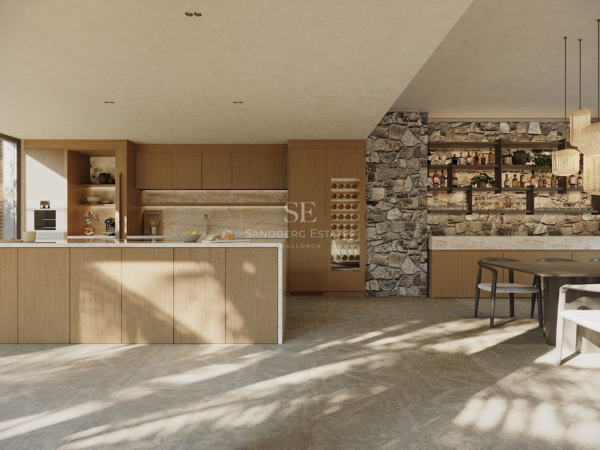 Cuisine moderne avec îlot en bois latté, mur en pierre naturelle, cave à vin intégrée et éclairage naturel chaleureux.