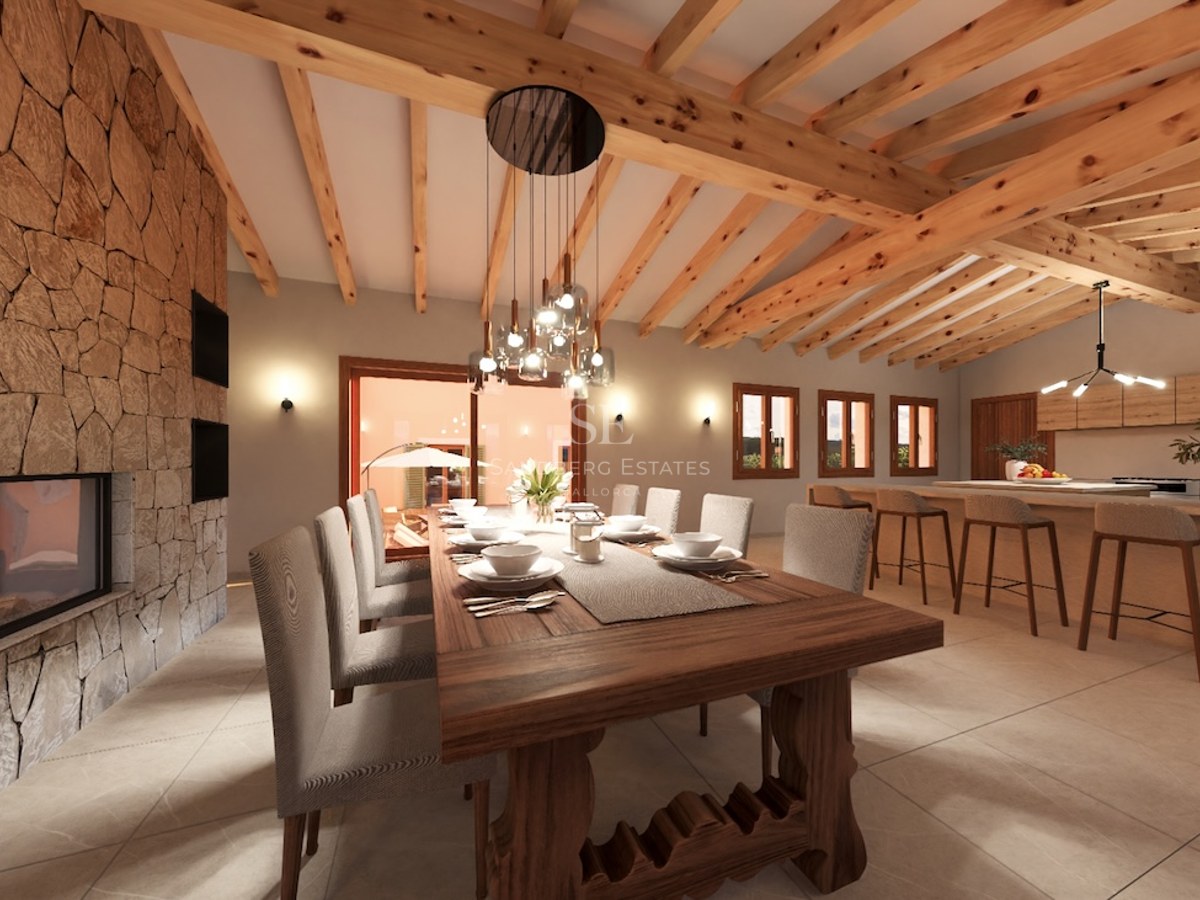 Spacious dining room featuring a massive wooden table, large stone fireplace, and exposed timber ceiling beams.