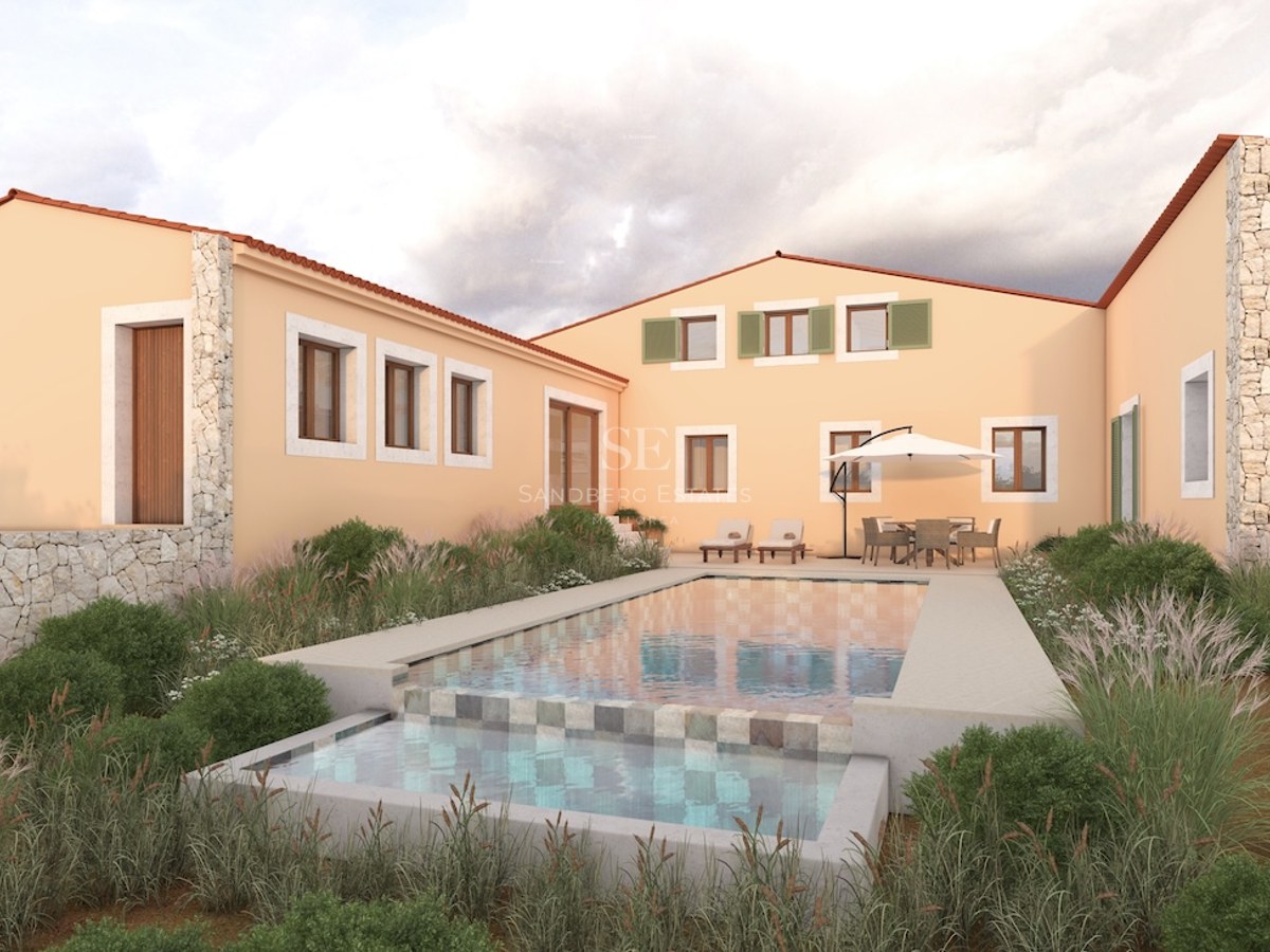 Mediterranean villa with peach-colored walls and a multi-level swimming pool surrounded by ornamental grasses.
