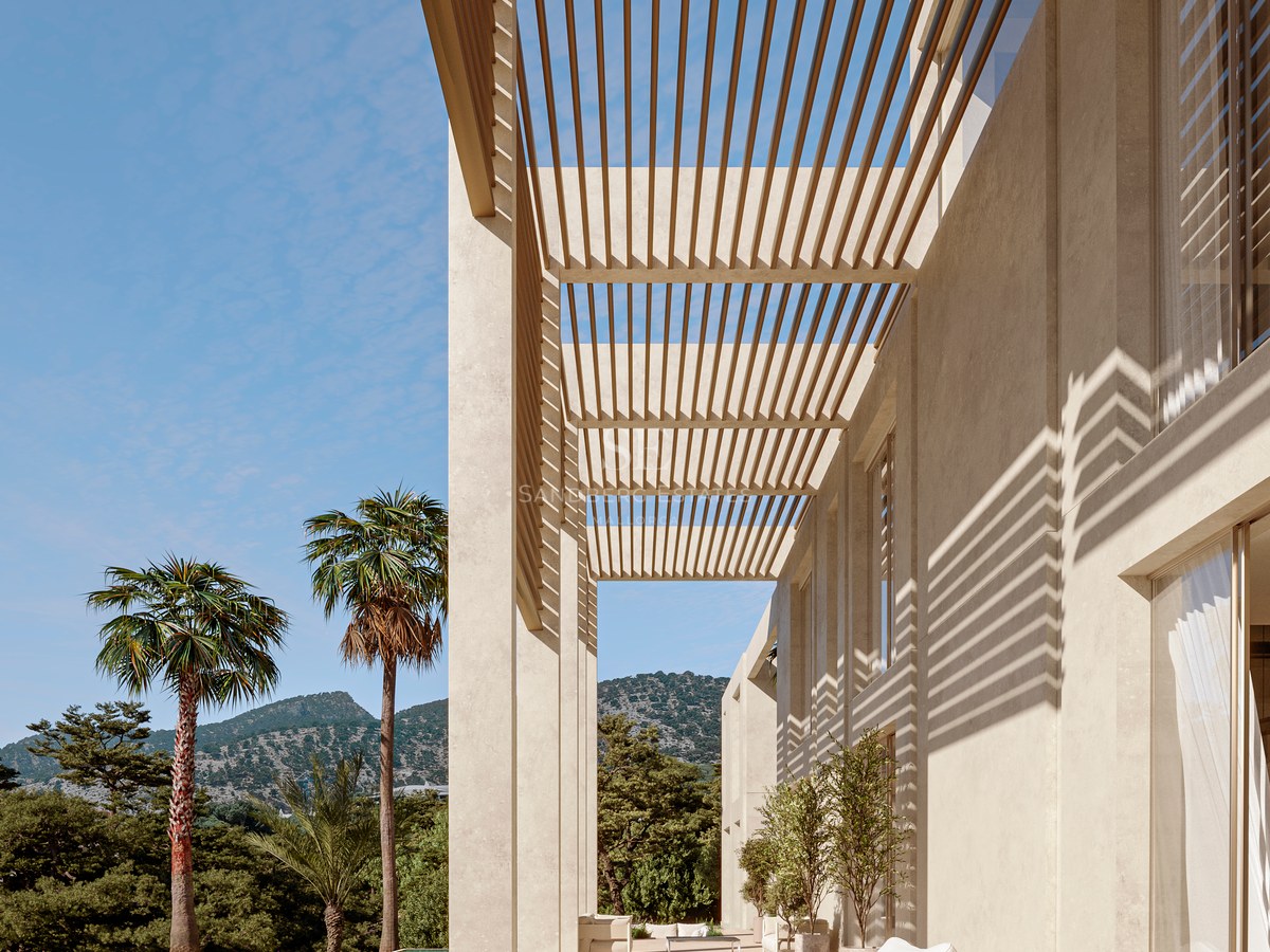 Modern stone terrace featuring a wooden slatted pergola, lounge seating, and a pool overlooking mountains.