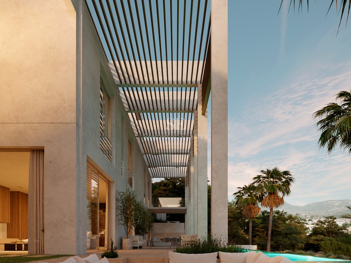 Luxury outdoor terrace featuring a sunken seating area with a fire pit, a slatted pergola, and a pool with mountain views.