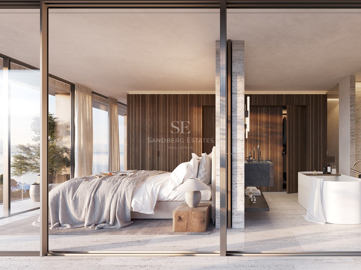 Modern master bedroom with fluted wood walls, travertine floors, and a freestanding tub overlooking the Mediterranean.