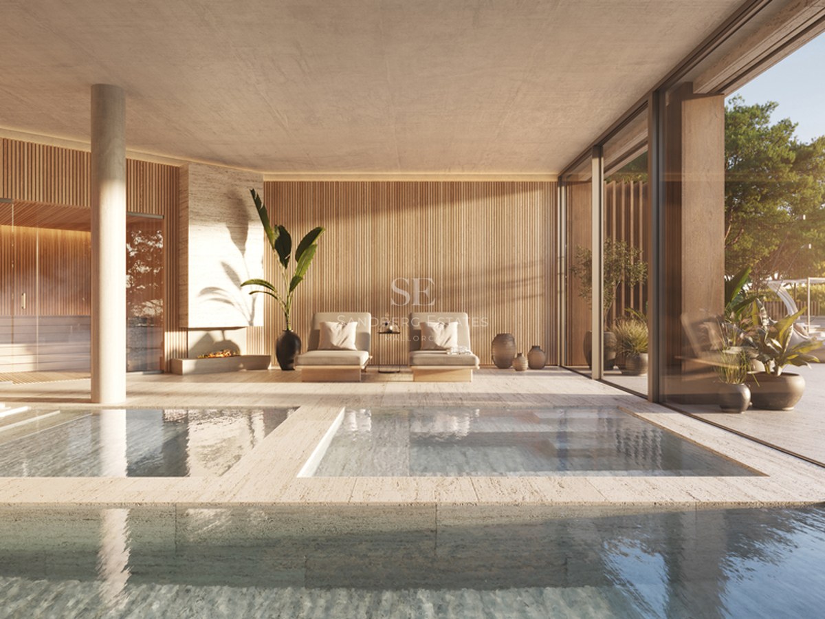 Indoor heated pool with travertine surround, integrated sauna, wood slat walls, and floor-to-ceiling glass doors.