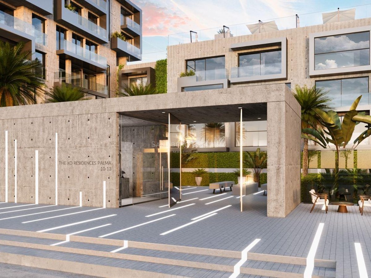 Modern exposed concrete entrance with linear floor lighting and palm trees.