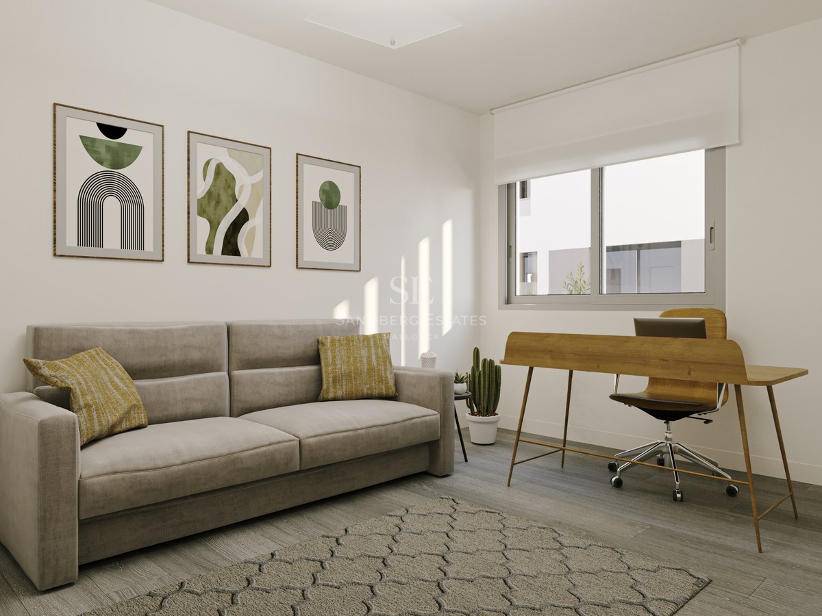 Contemporary home office featuring a grey sofa, wooden desk, ergonomic chair, and abstract wall art.