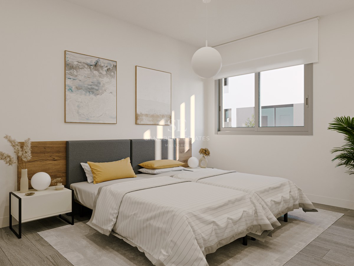Bright bedroom featuring twin beds, wood and fabric headboard, minimalist bedside table, and window with natural light.