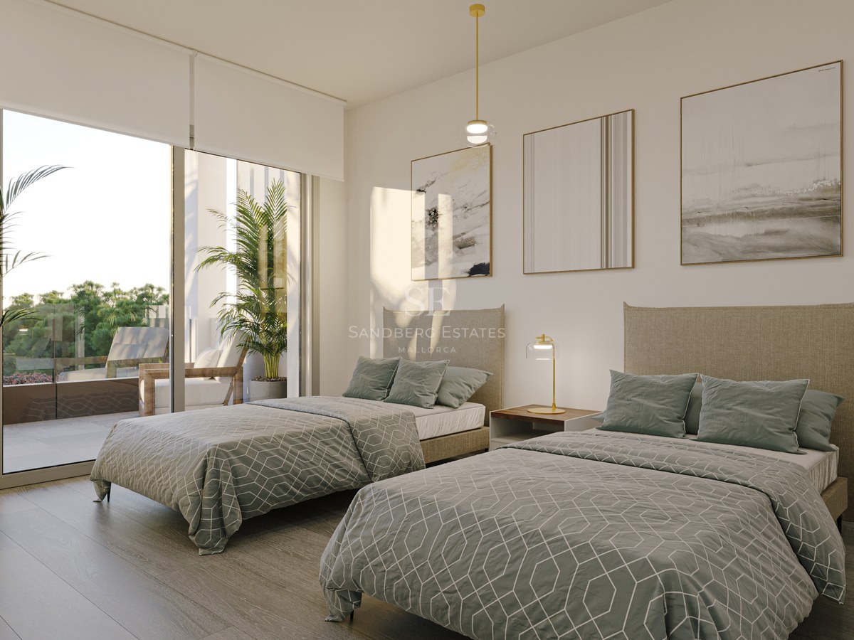 Contemporary bedroom featuring twin beds with sage green linens and large glass doors opening to a sunlit terrace.