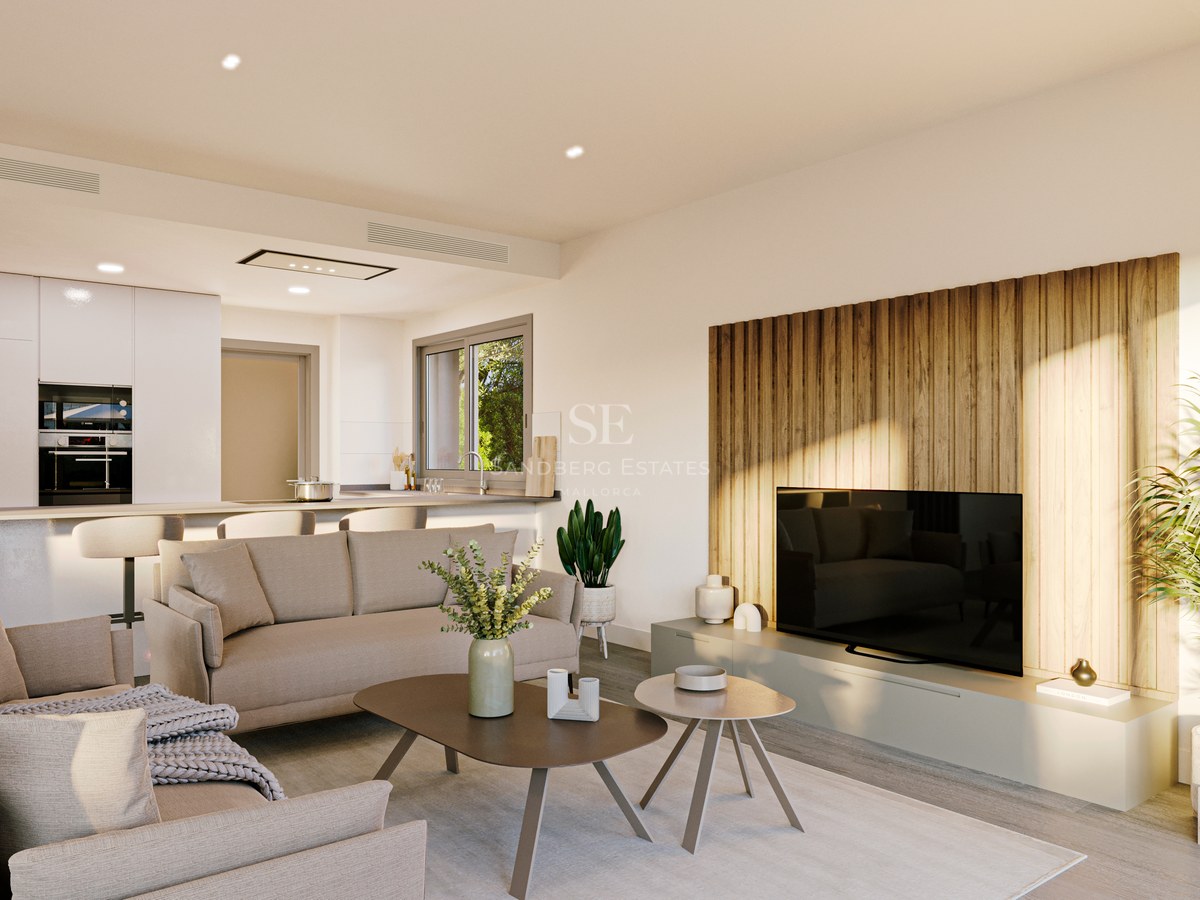 Bright living room featuring a beige sofa, wood-slatted TV wall, and an open-concept kitchen with breakfast bar.