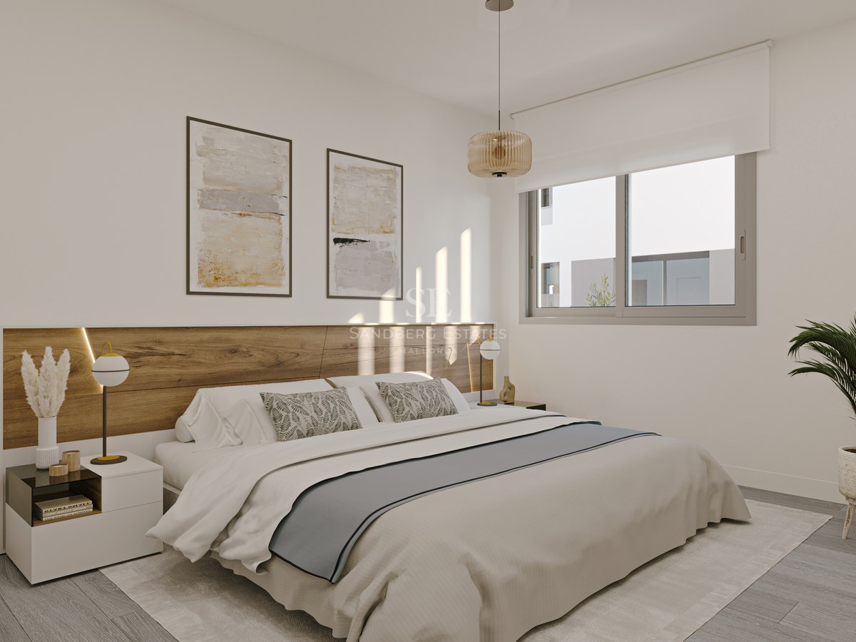 Modern master bedroom featuring an integrated wooden headboard, large window, neutral bedding, and an indoor palm plant.