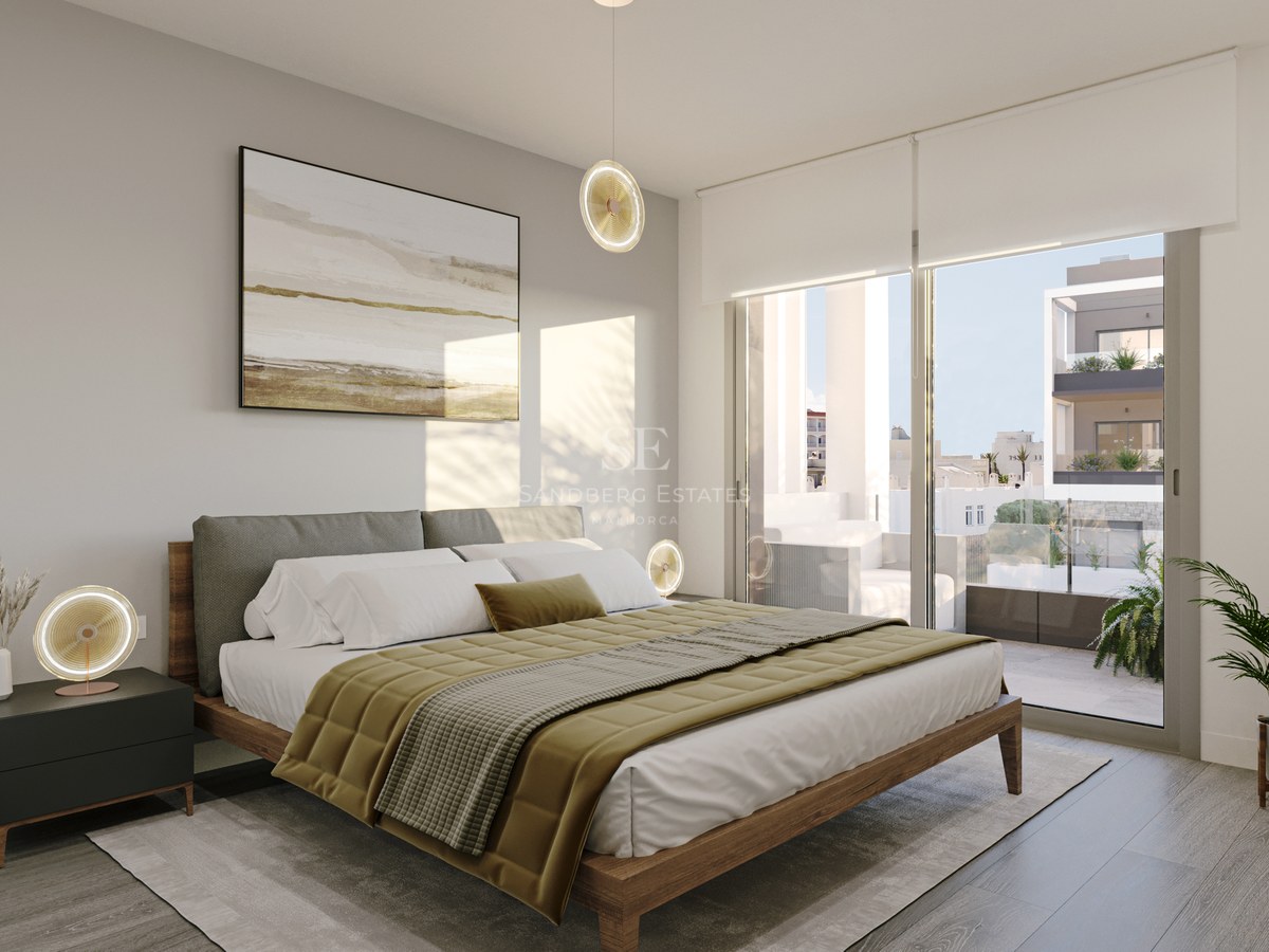 A modern bedroom featuring a wooden bed frame, olive textiles, and sliding glass doors opening to a balcony.