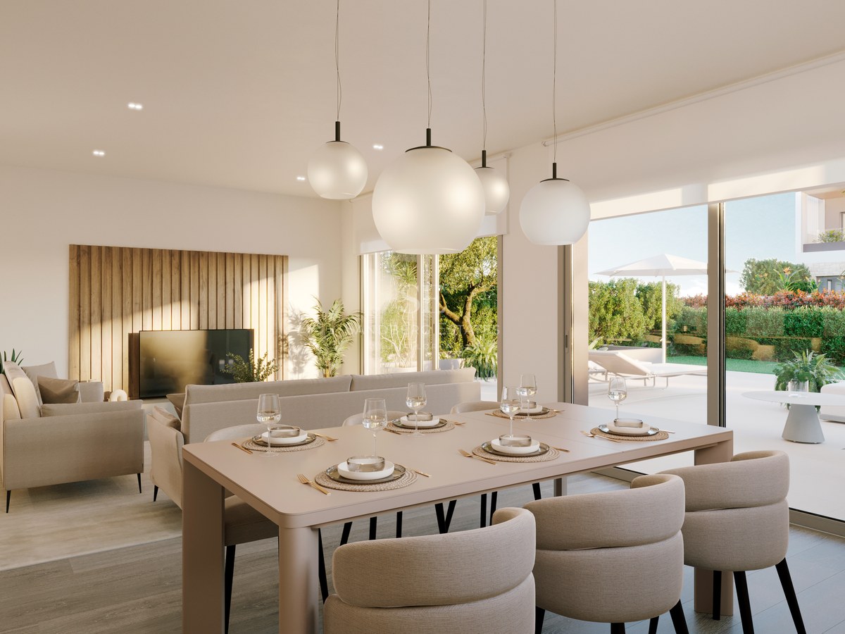 Modern open-plan dining room with beige chairs and sphere pendant lights leading to a sunlit garden terrace.