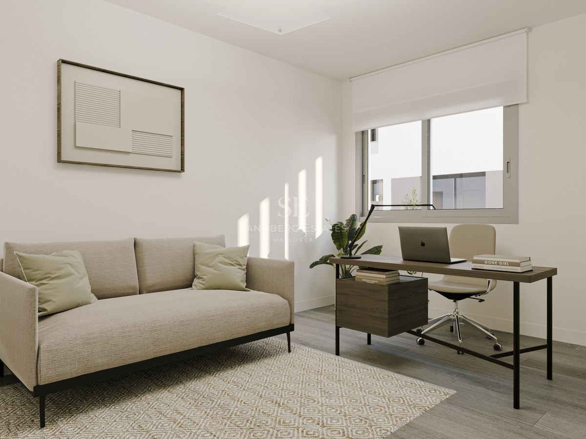 Contemporary home office featuring a beige sofa, wooden desk, and large window with natural light shadows on white walls.