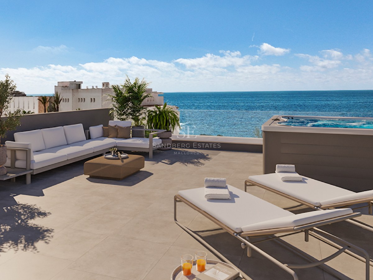 Modern rooftop terrace featuring a private hot tub, white lounge furniture, and sunbeds overlooking the Mediterranean sea.