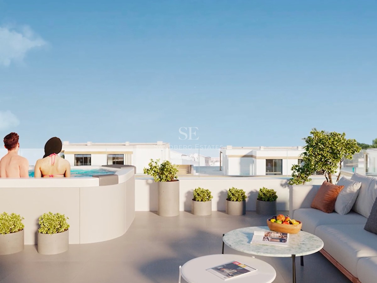 Rooftop terrace featuring a modern jacuzzi, lounge seating, marble tables, and glass railings under a clear blue sky.