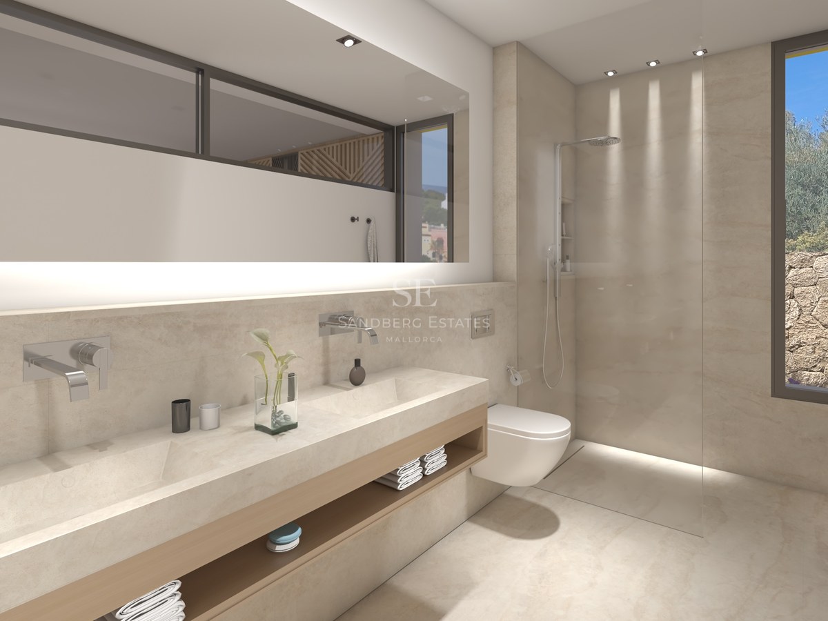 Salle de bain principale moderne avec double vasque en pierre, grand miroir rétroéclairé et douche vitrée.