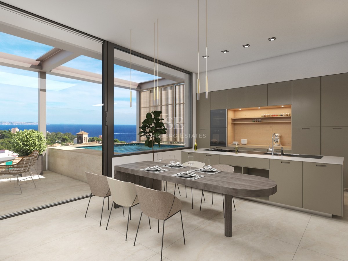 Cuisine moderne et coin repas avec de grandes baies vitrées s'ouvrant sur une terrasse avec piscine et vue mer.