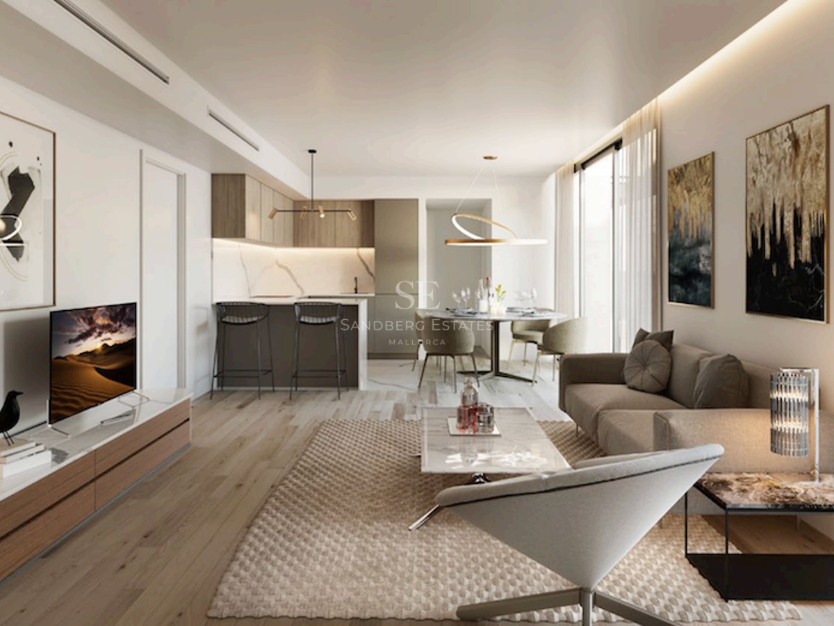 Modern living room featuring a beige sofa, marble coffee table, wood flooring, and an integrated kitchen in the background.