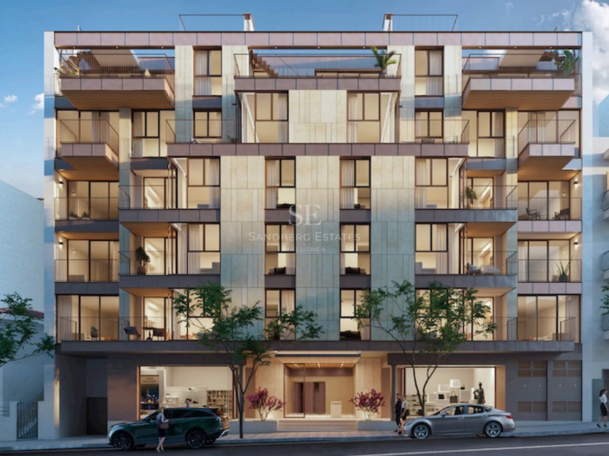 Front view of a contemporary six-story apartment building with beige stone cladding, large windows, and balconies.