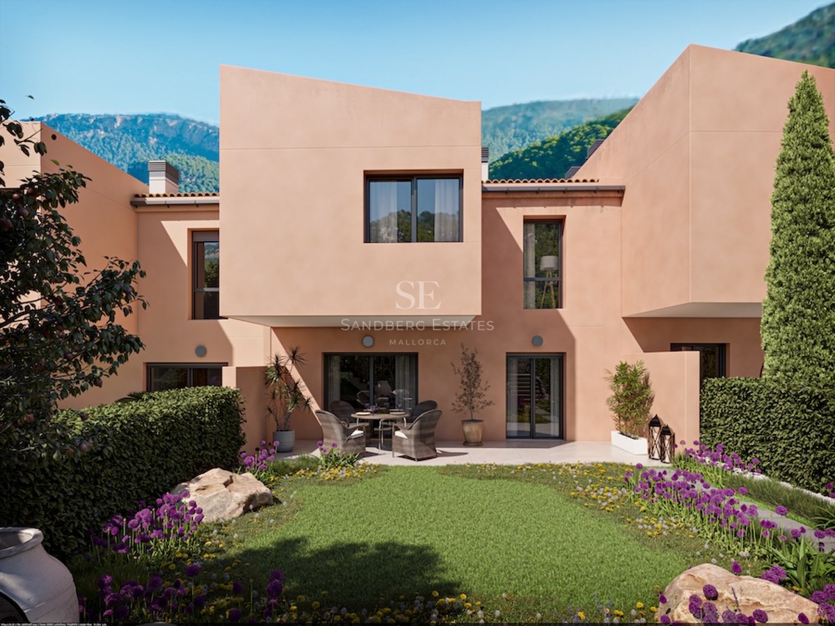 Modern peach-colored villa facade featuring geometric architecture, a manicured garden with lavender, and mountain views.